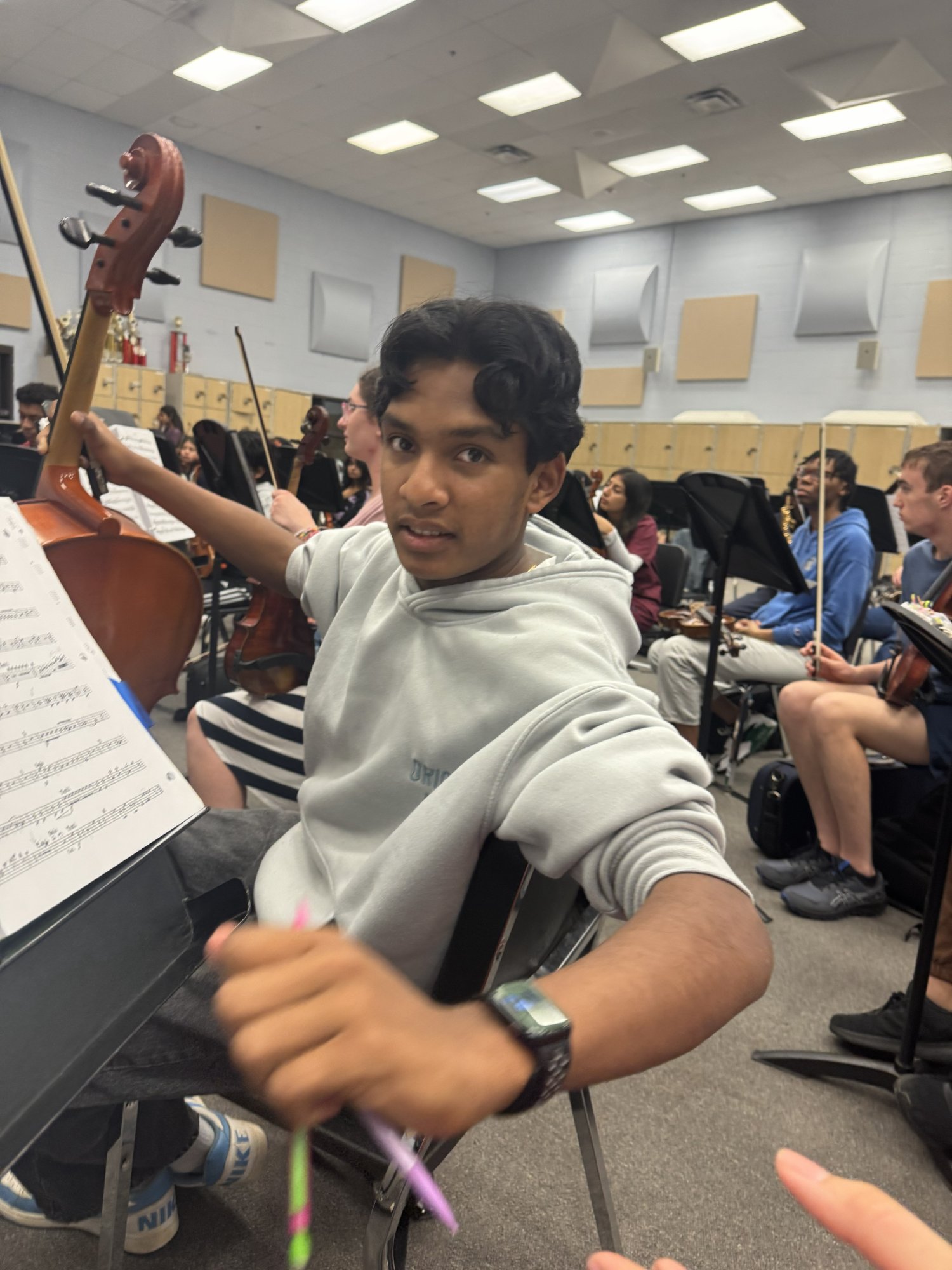 Zayne playing cello in orchestra rehearsal