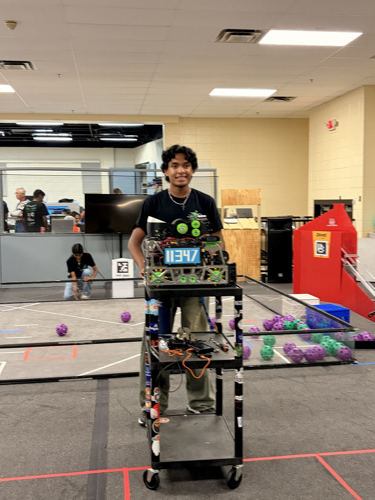 Zayne with CircuitRunners robot #11347 at FTC competition